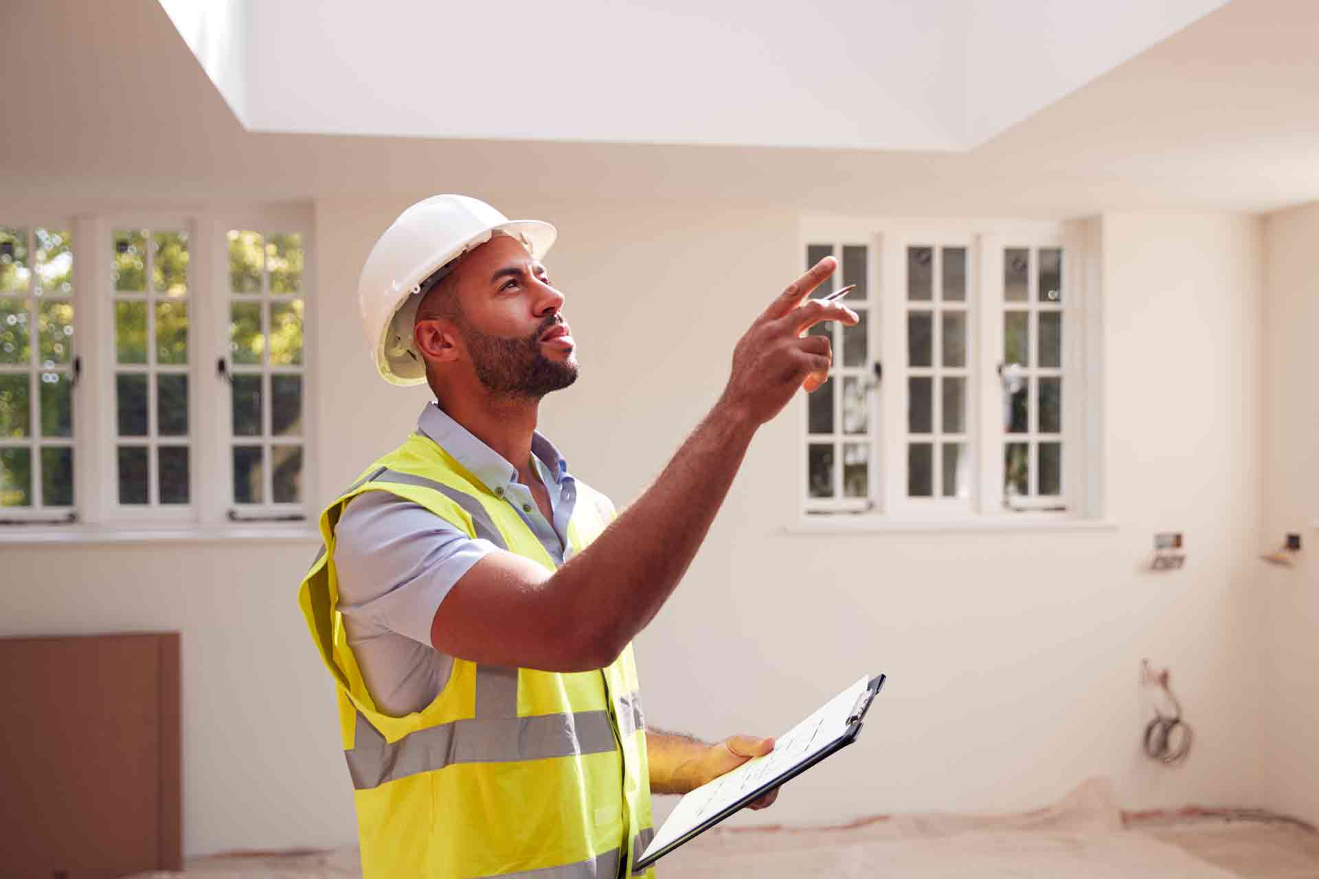 Third Party Wall Surveyors Manchester reviewing plans between two parties during a dispute